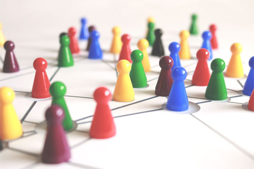 Colorful game pieces on a board represent a remote team in business