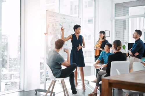 A diverse group of professionals engaged in a collaborative meeting in a modern office setting